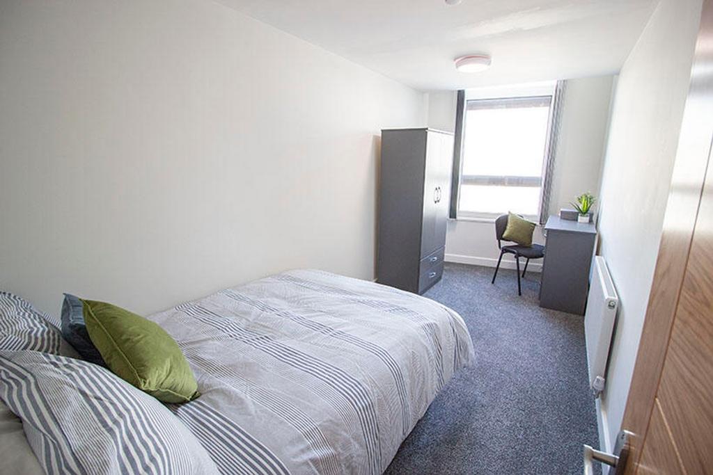 This inviting double bedroom features a comfort...