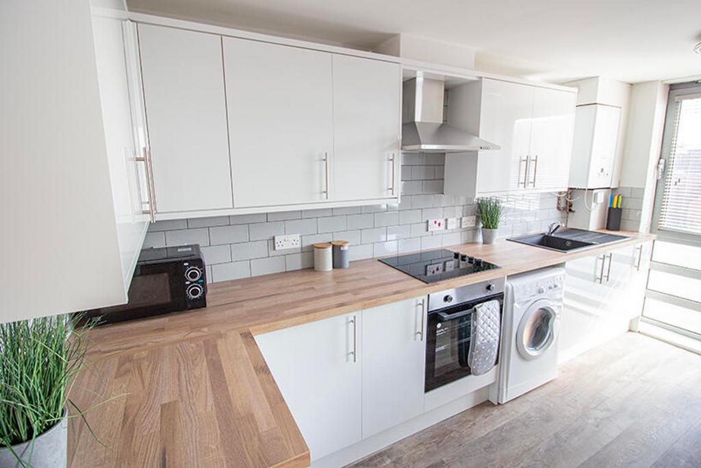 This modern kitchen features sleek cabinetry an...