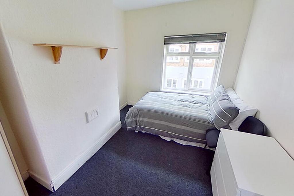 Bright and cozy double bedroom featuring a comf...