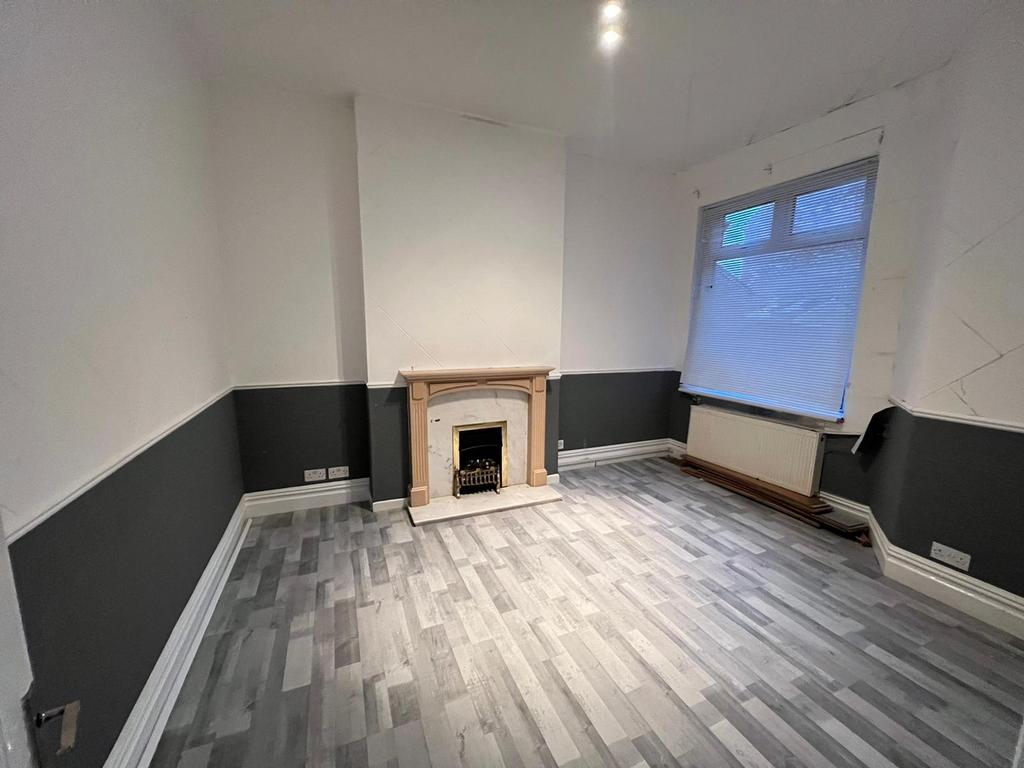 Spacious living room featuring a charming firep...