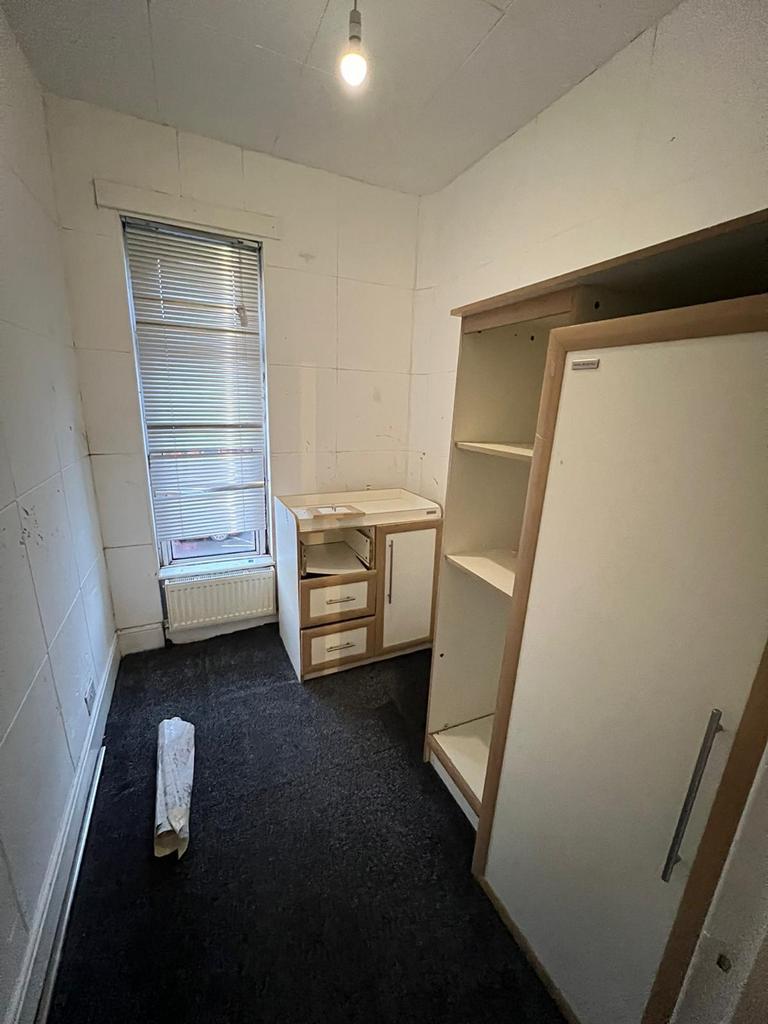 A cozy room featuring practical storage solutio...