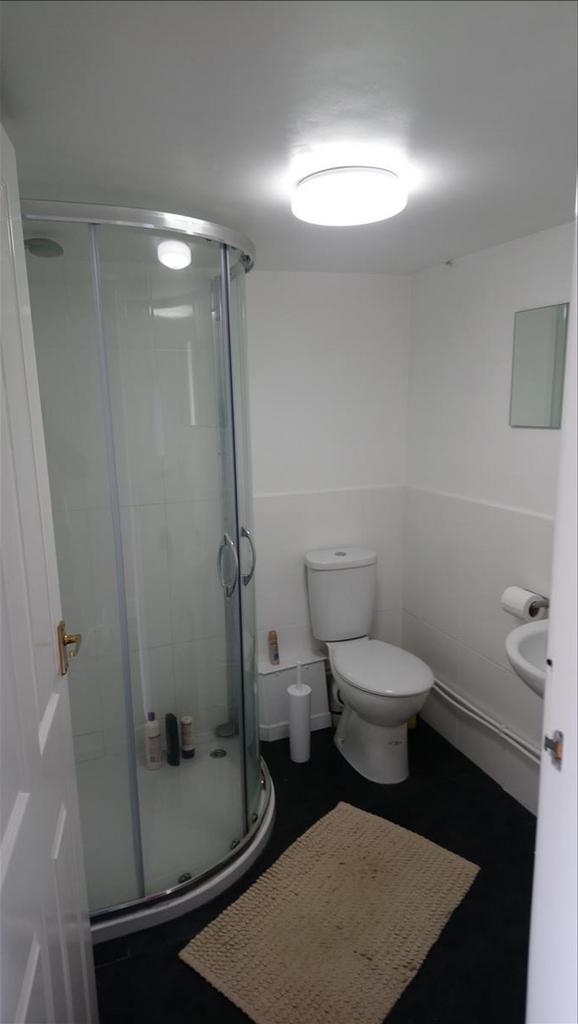 This modern bathroom features a spacious shower...