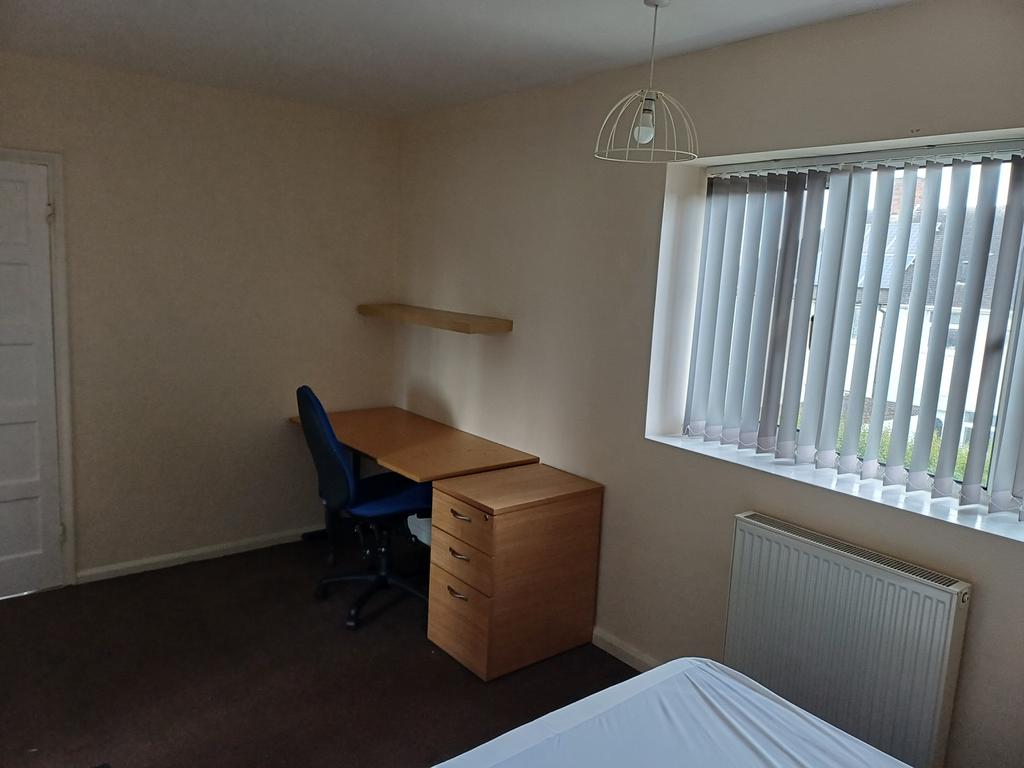 Spacious double bedroom featuring a comfortable...