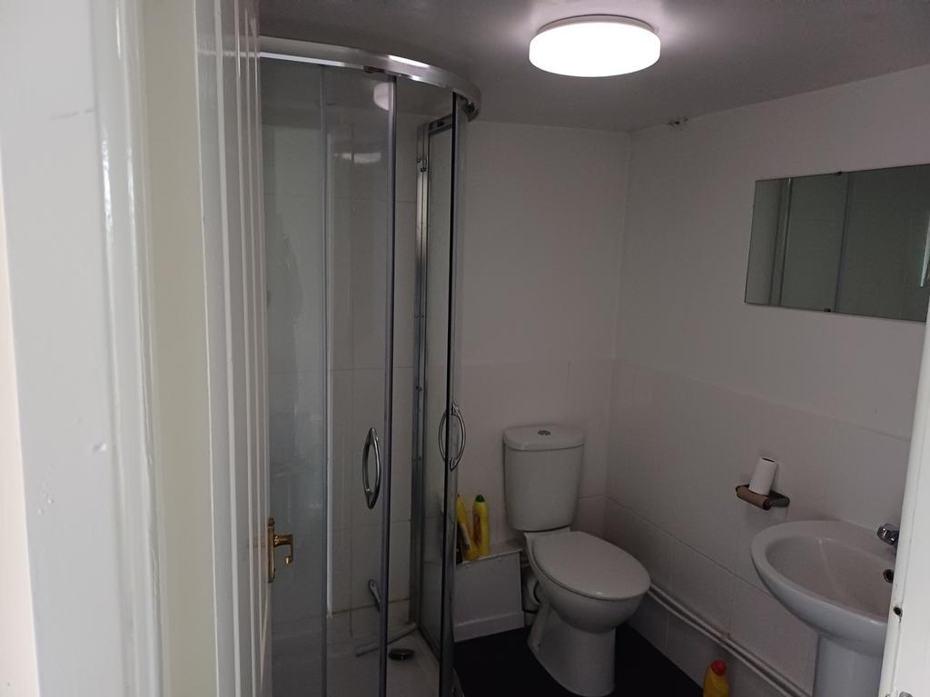 A modern bathroom featuring a sleek shower encl...