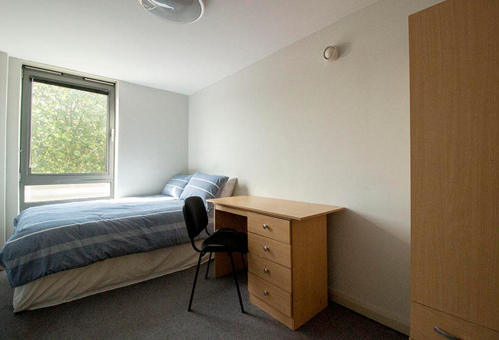 This inviting double bedroom features a comfort...