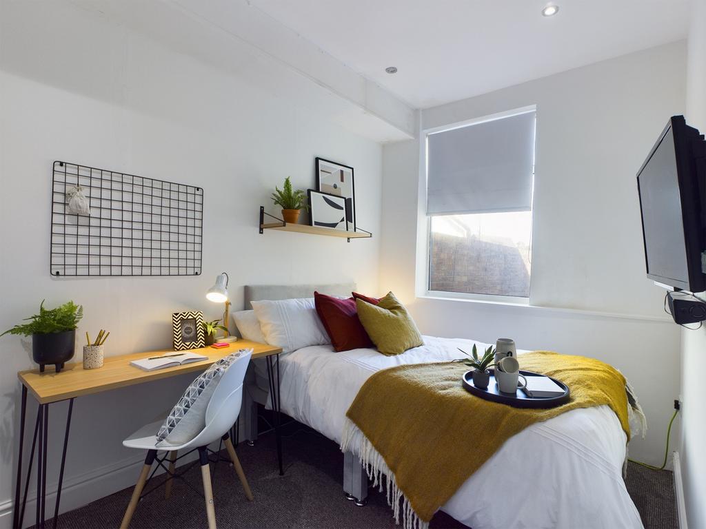 A bright and stylish double bedroom featuring m...