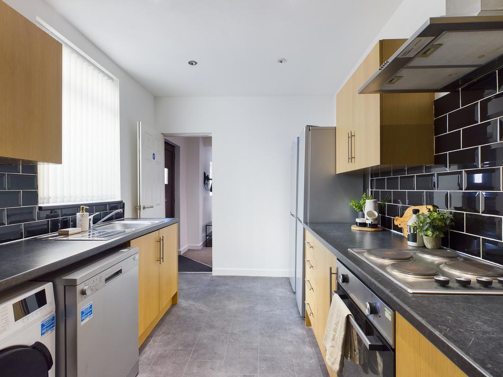 A modern and tidy kitchen featuring ample count...