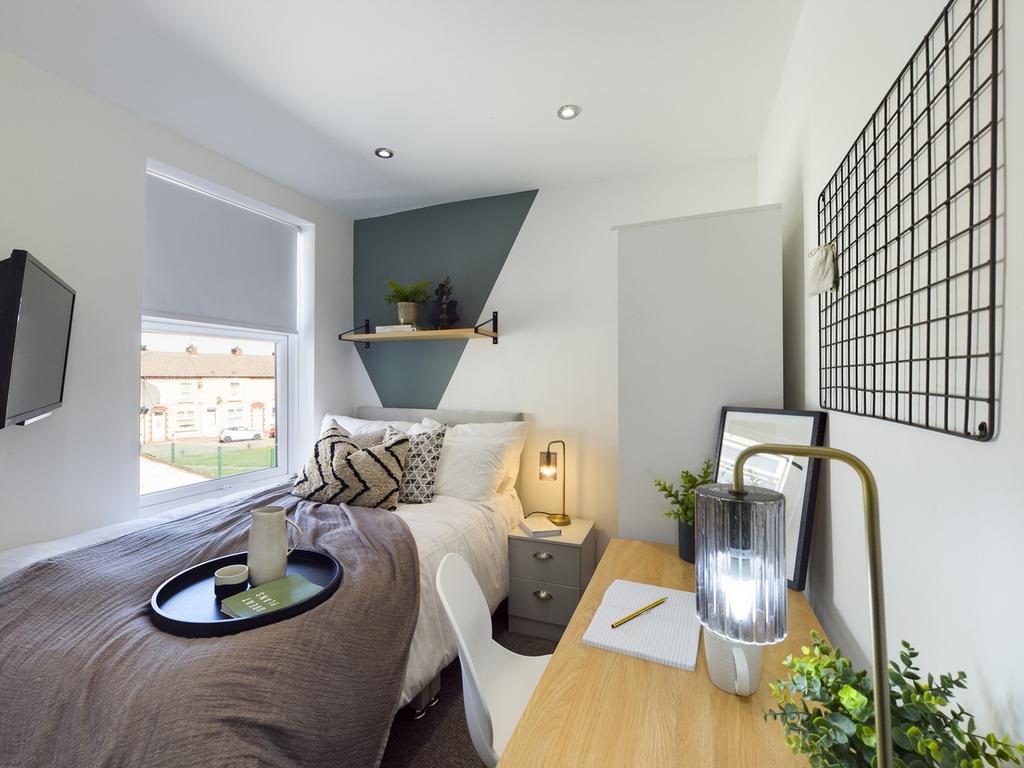 A bright and inviting double bedroom featuring ...