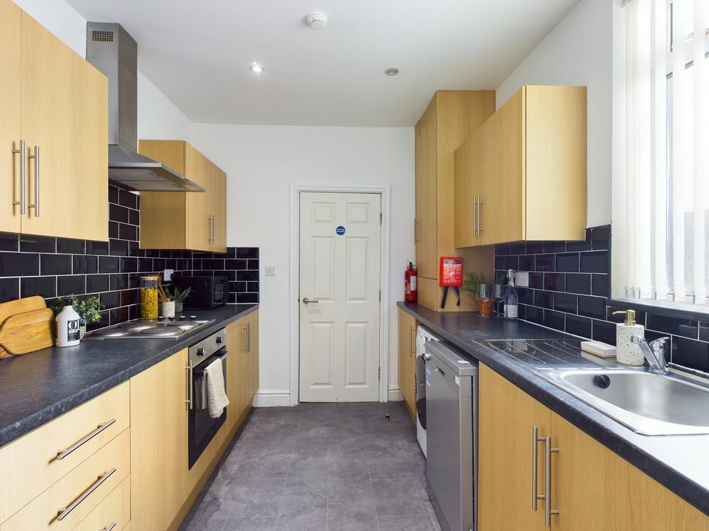 A bright and modern kitchenette with ample stor...