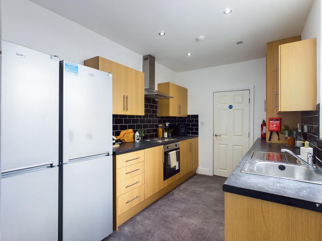 A modern and clean kitchen with ample storage a...