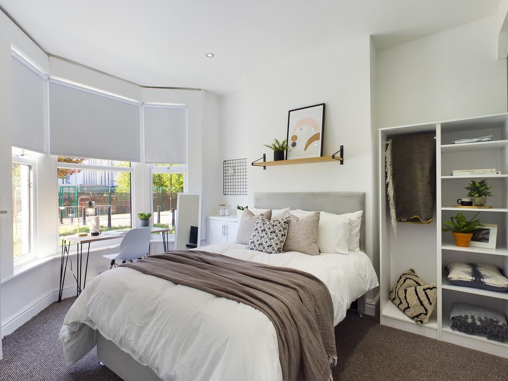 A bright and inviting double bedroom with moder...