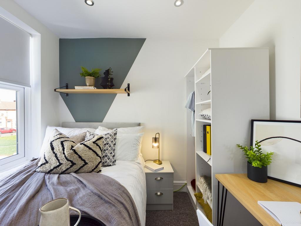 A stylish and inviting double bedroom with ampl...