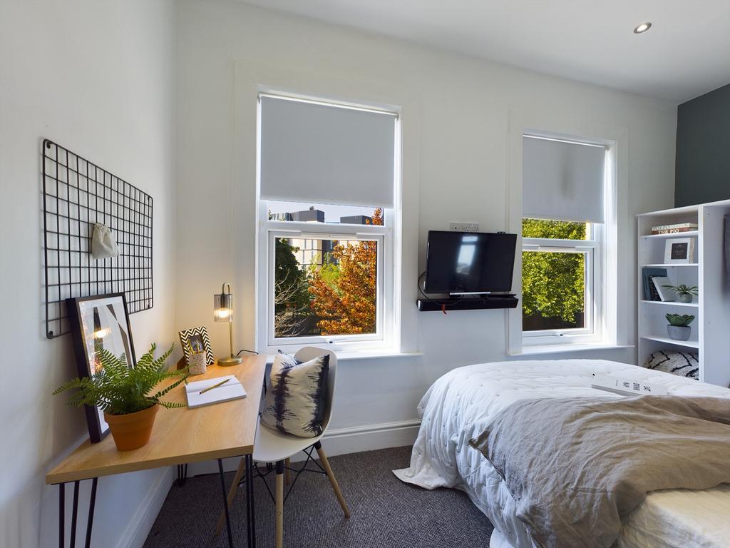 A bright and inviting double bedroom featuring ...