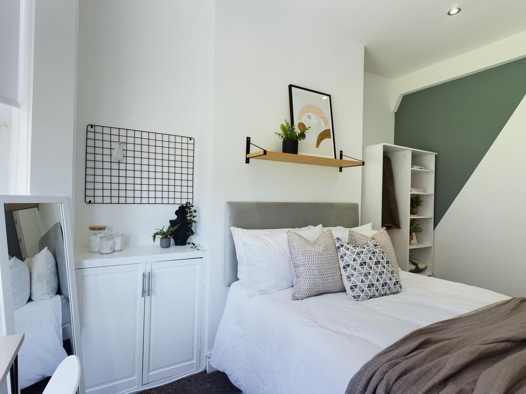 A bright and inviting double bedroom with moder...
