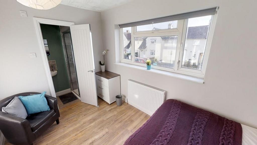 This inviting double bedroom features a cozy at...