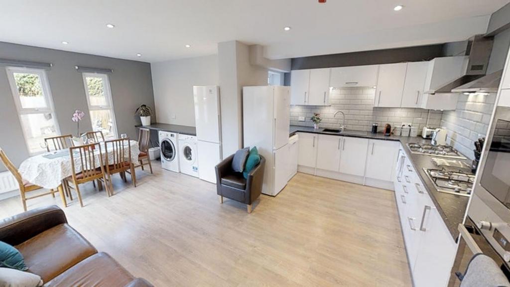 This modern kitchen offers a spacious layout wi...