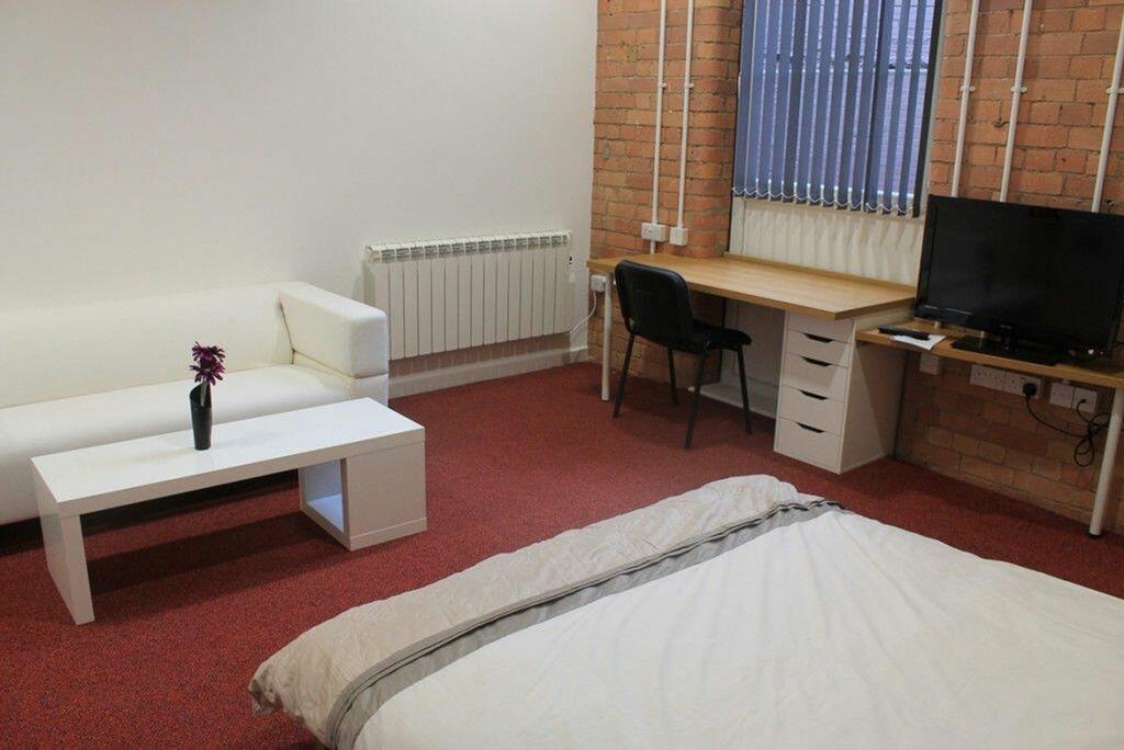 This spacious double bedroom features a cozy at...