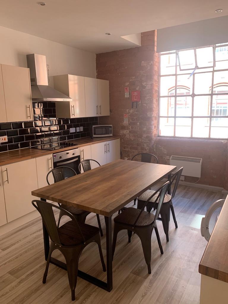 A stylish kitchen featuring modern appliances, ...