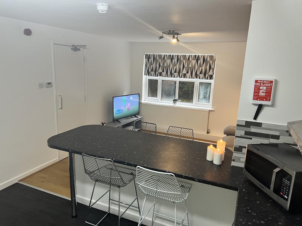 Modern kitchen with a stylish breakfast bar, eq...