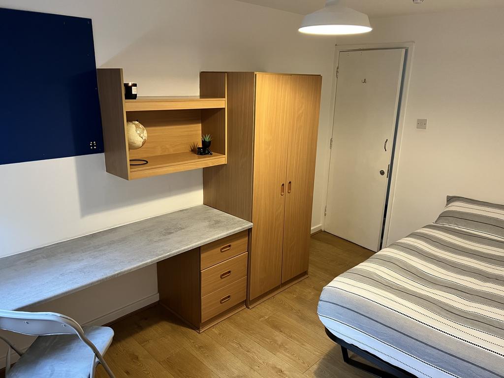 Cozy double bedroom featuring a well-organized ...