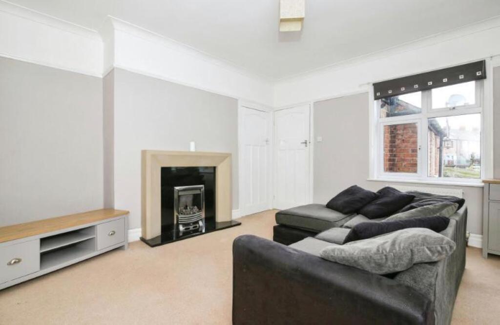 Spacious and inviting living room with a cozy f...