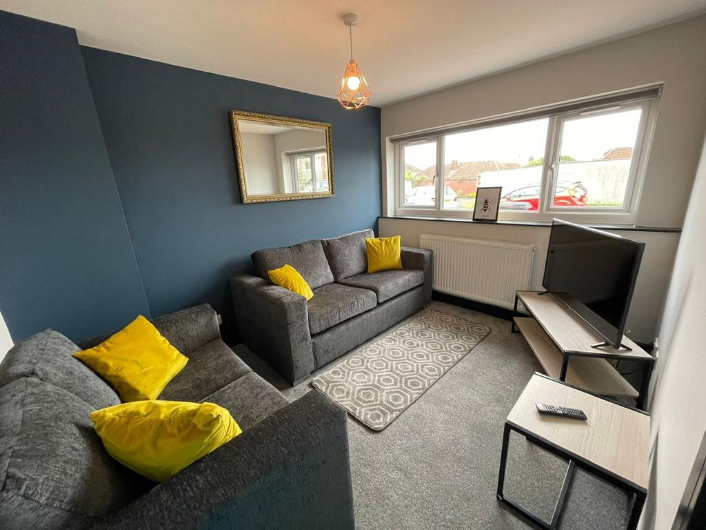 This inviting living room features cozy gray so...