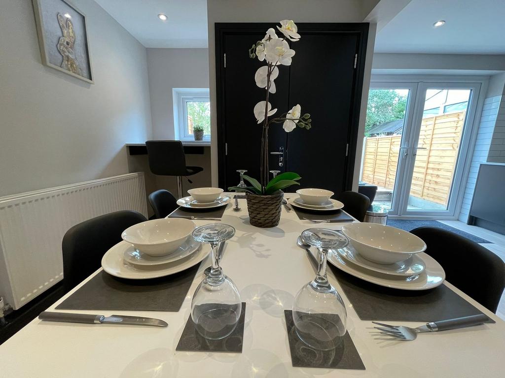 This modern kitchen features a stylish dining a...