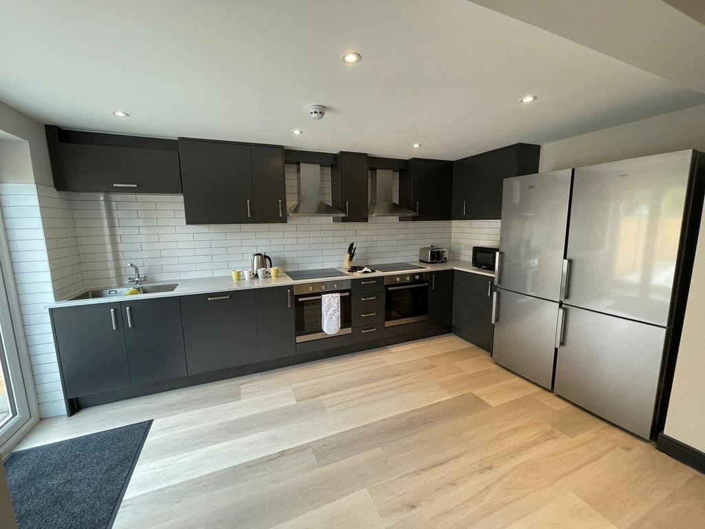 A modern kitchen featuring sleek cabinetry and ...