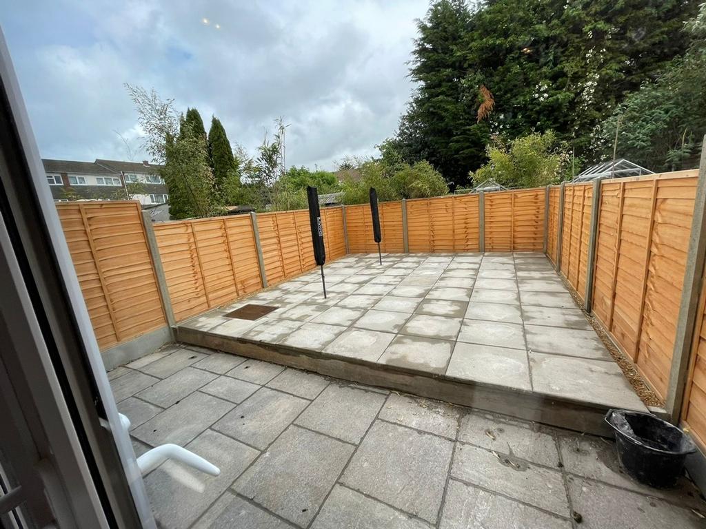 This spacious garden area features a well-maint...