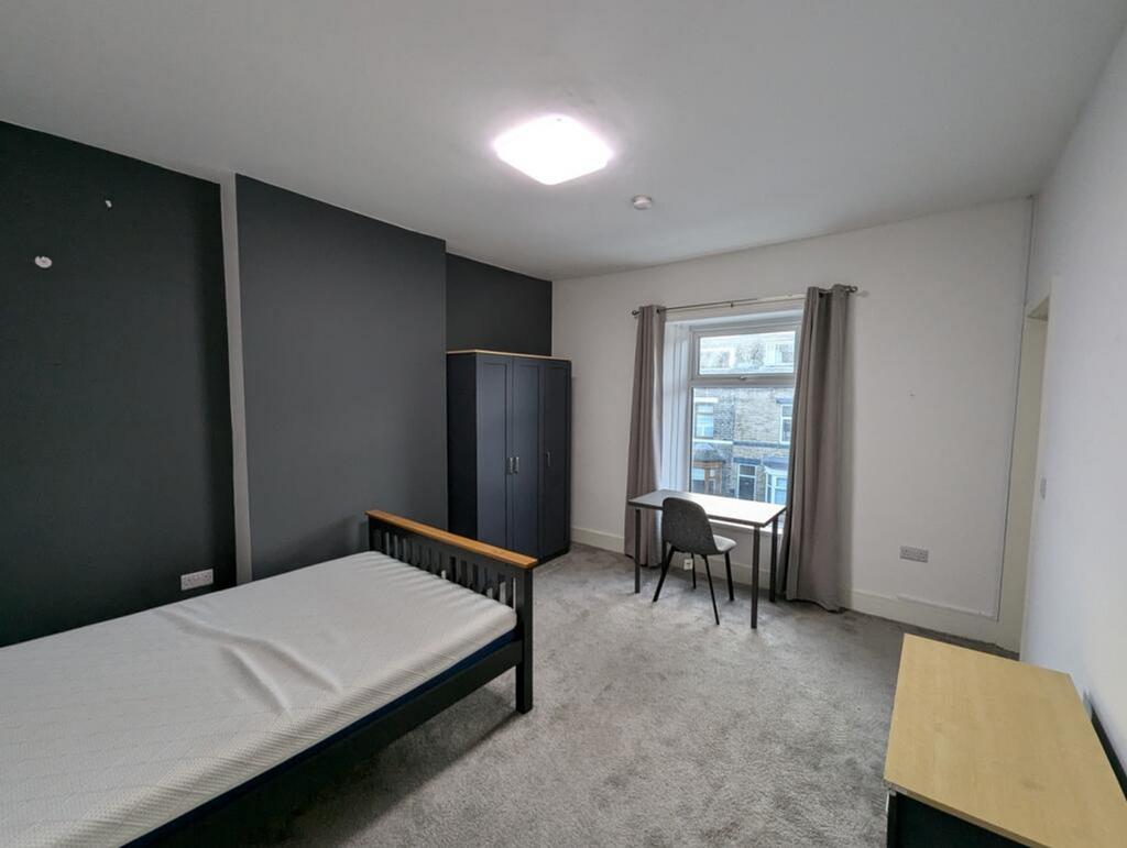 Spacious double bedroom featuring a comfortable...