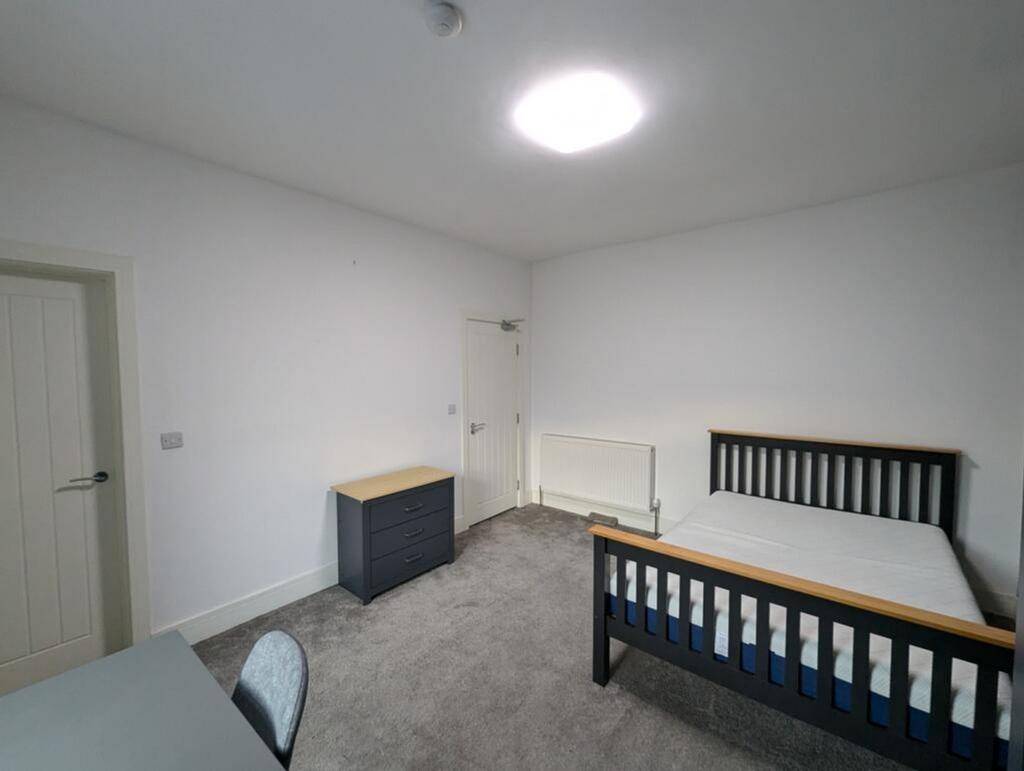 Spacious double bedroom featuring a comfortable...