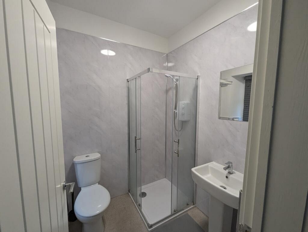 A modern bathroom featuring a sleek shower, con...