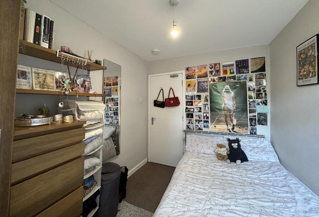 This inviting double bedroom features a cozy la...