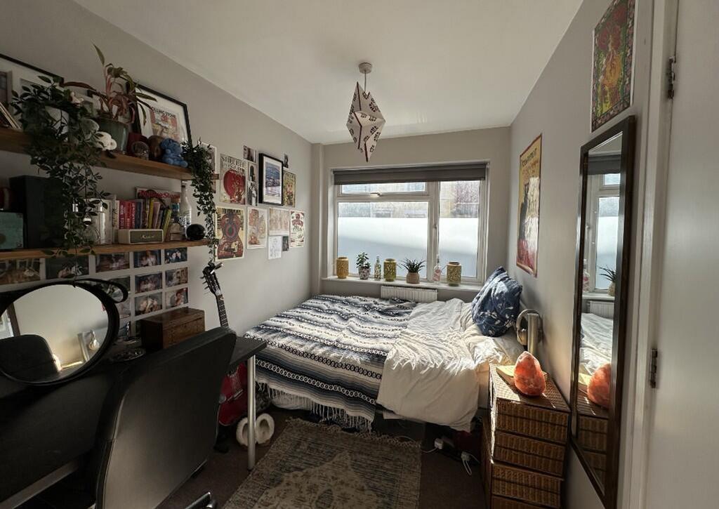 This cozy double bedroom features a comfortable...