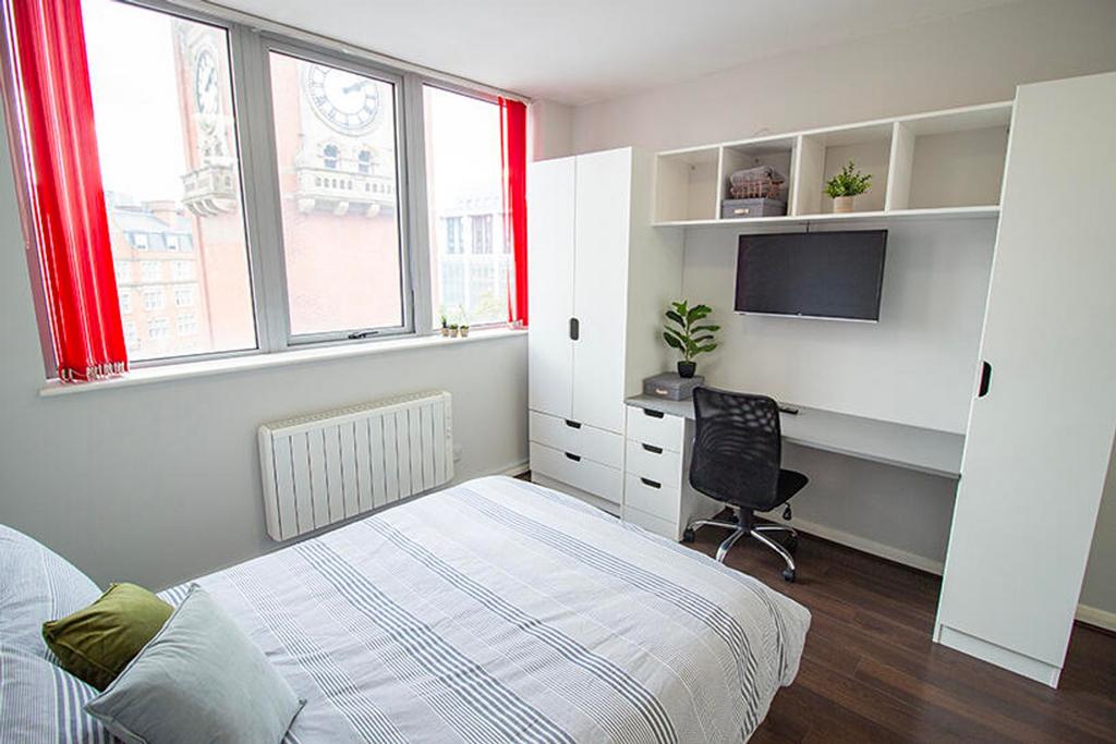 This inviting double bedroom features large win...