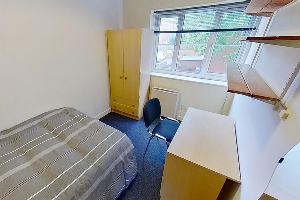 Cozy double bedroom featuring a comfortable bed...