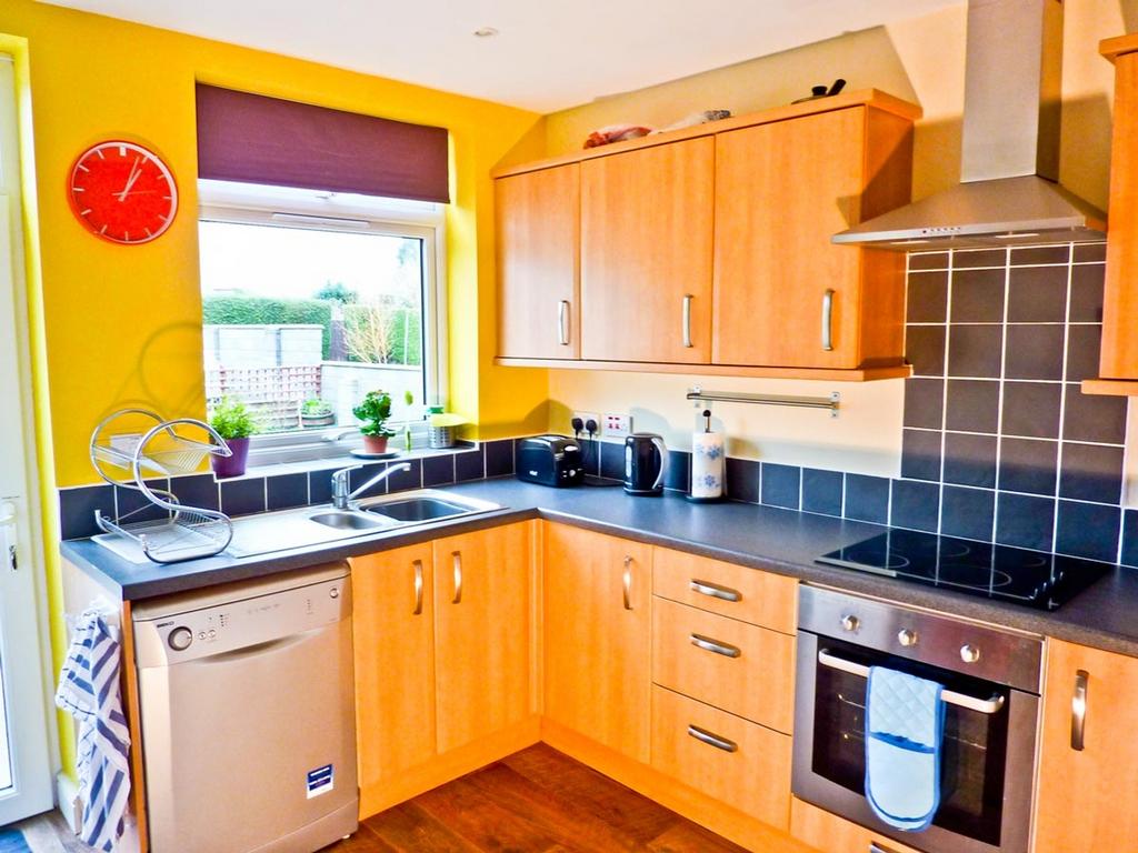 A bright and modern kitchen with ample storage ...