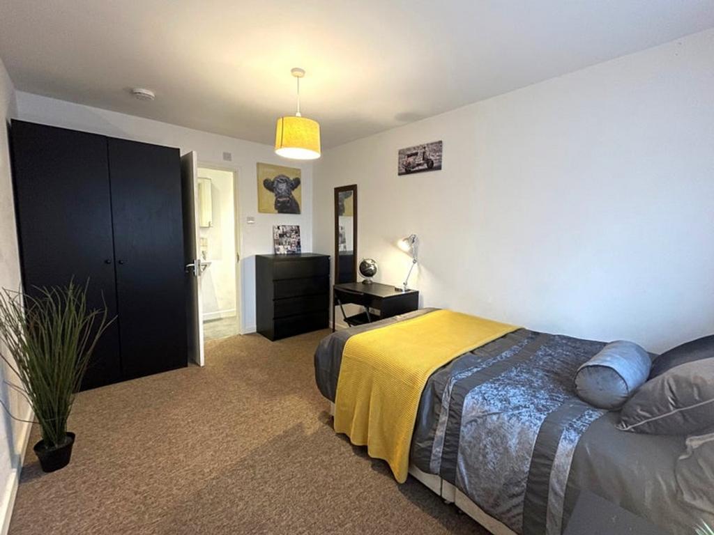 This inviting double bedroom features a cozy at...