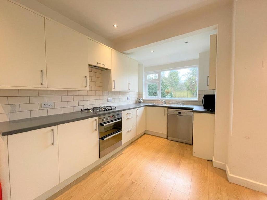 This modern kitchen features sleek cabinetry, a...