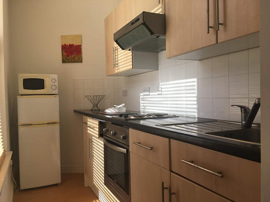 Bright and modern kitchen featuring sleek cabin...