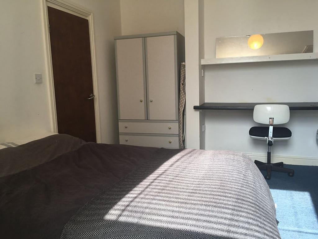 A cozy double bedroom featuring ample natural l...
