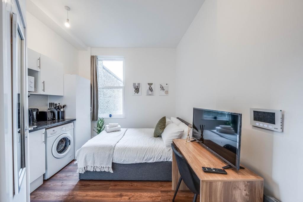 This inviting double bedroom features a cozy la...