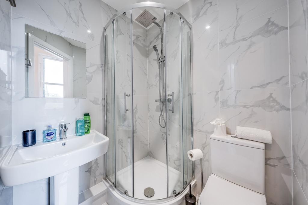 Modern bathroom featuring a stylish glass showe...