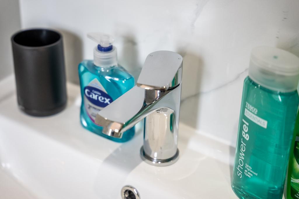 A modern bathroom featuring a sleek faucet and ...
