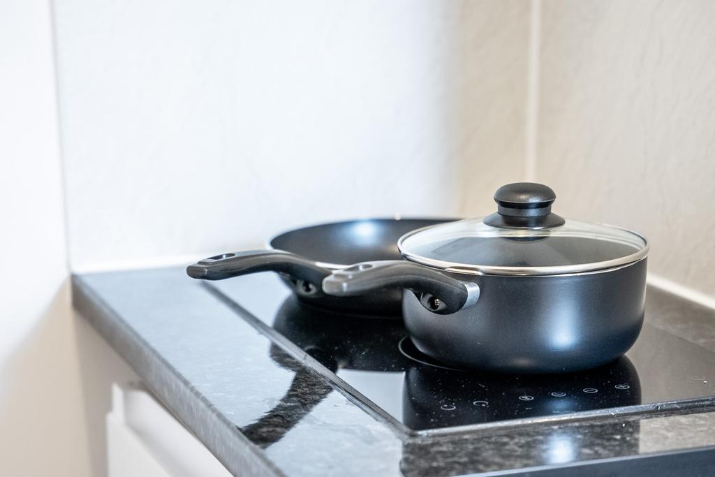 A modern kitchen setup featuring a sleek black ...