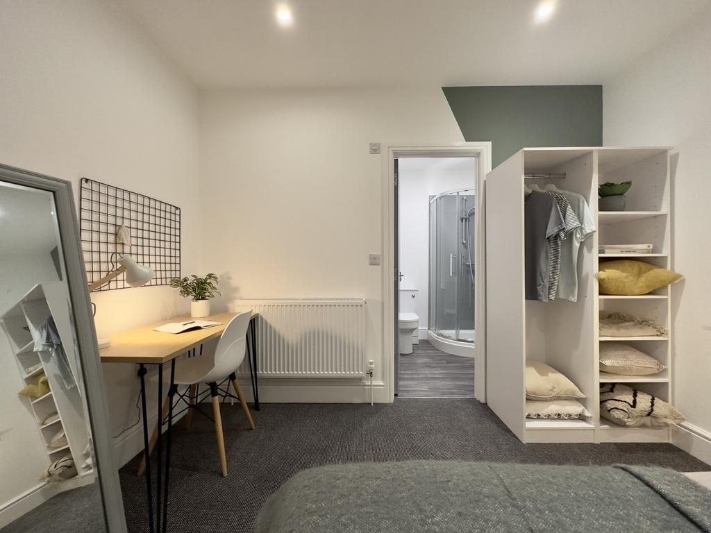 A bright and spacious double bedroom featuring ...