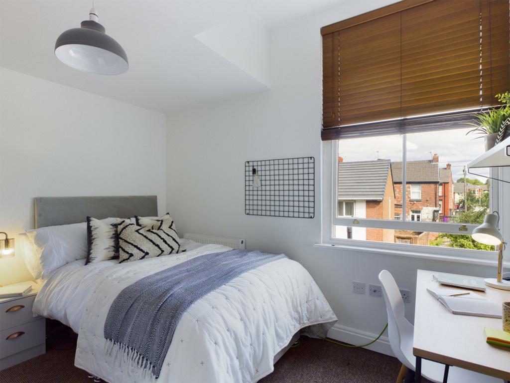 A bright and inviting double bedroom featuring ...