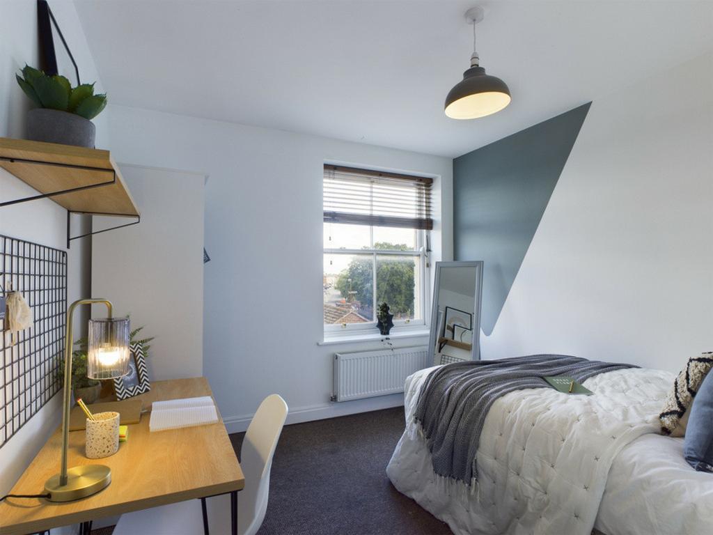 A stylish and well-lit double bedroom featuring...