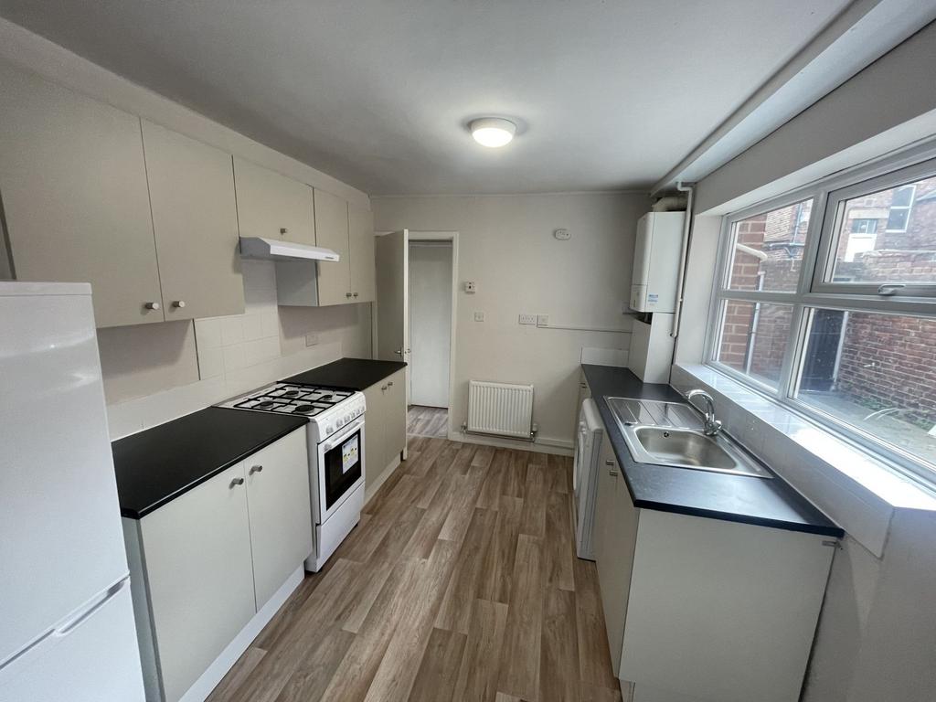 Bright, modern galley kitchen with large window...
