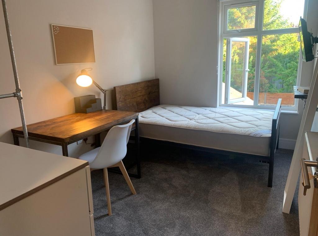 This inviting double bedroom features a comfort...